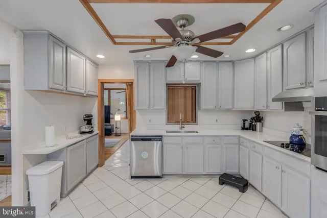 a kitchen with a sink window and cabinets