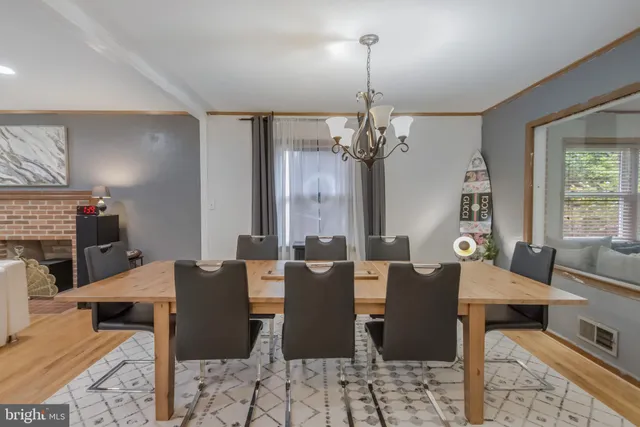 a living room with furniture and a view of kitchen