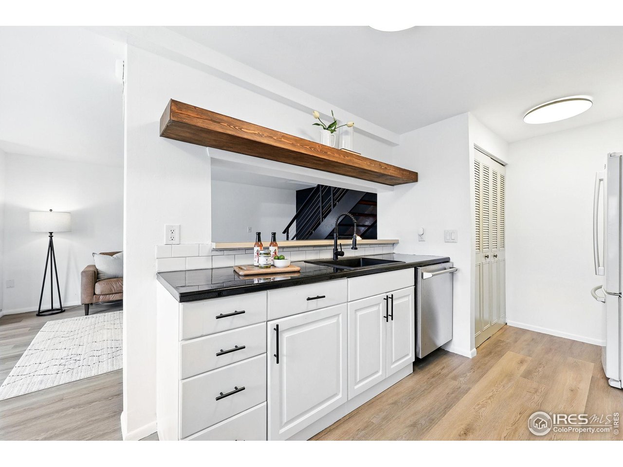 3390 34th Street, Unit B Boulder, CO 80301 - Photo 12 of 31 a kitchen with granite countertop a sink and cabinets
