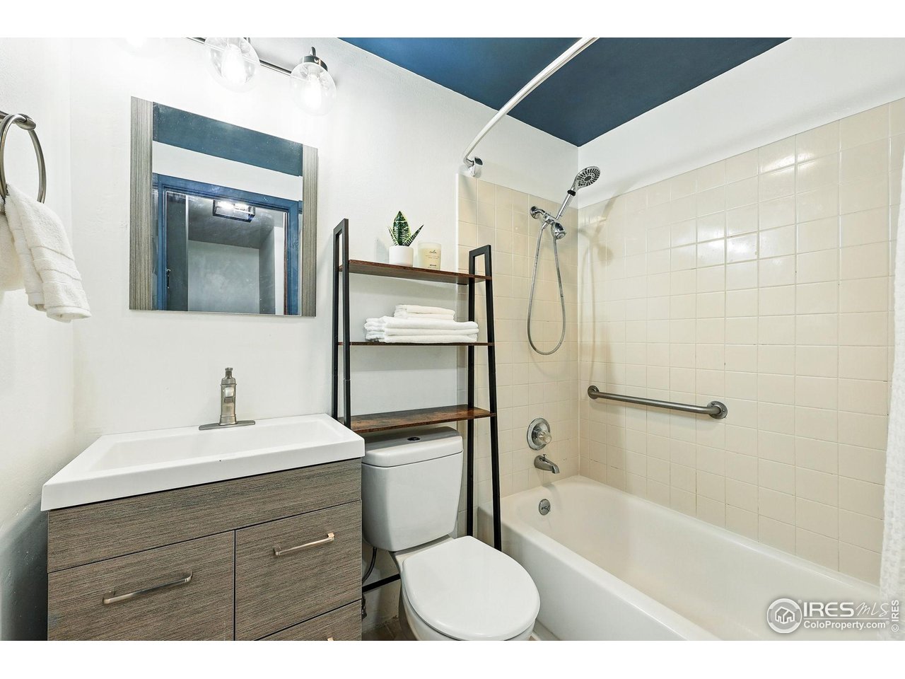 3390 34th Street, Unit B Boulder, CO 80301 - Photo 22 of 31 a bathroom with a sink a toilet and shower a mirror