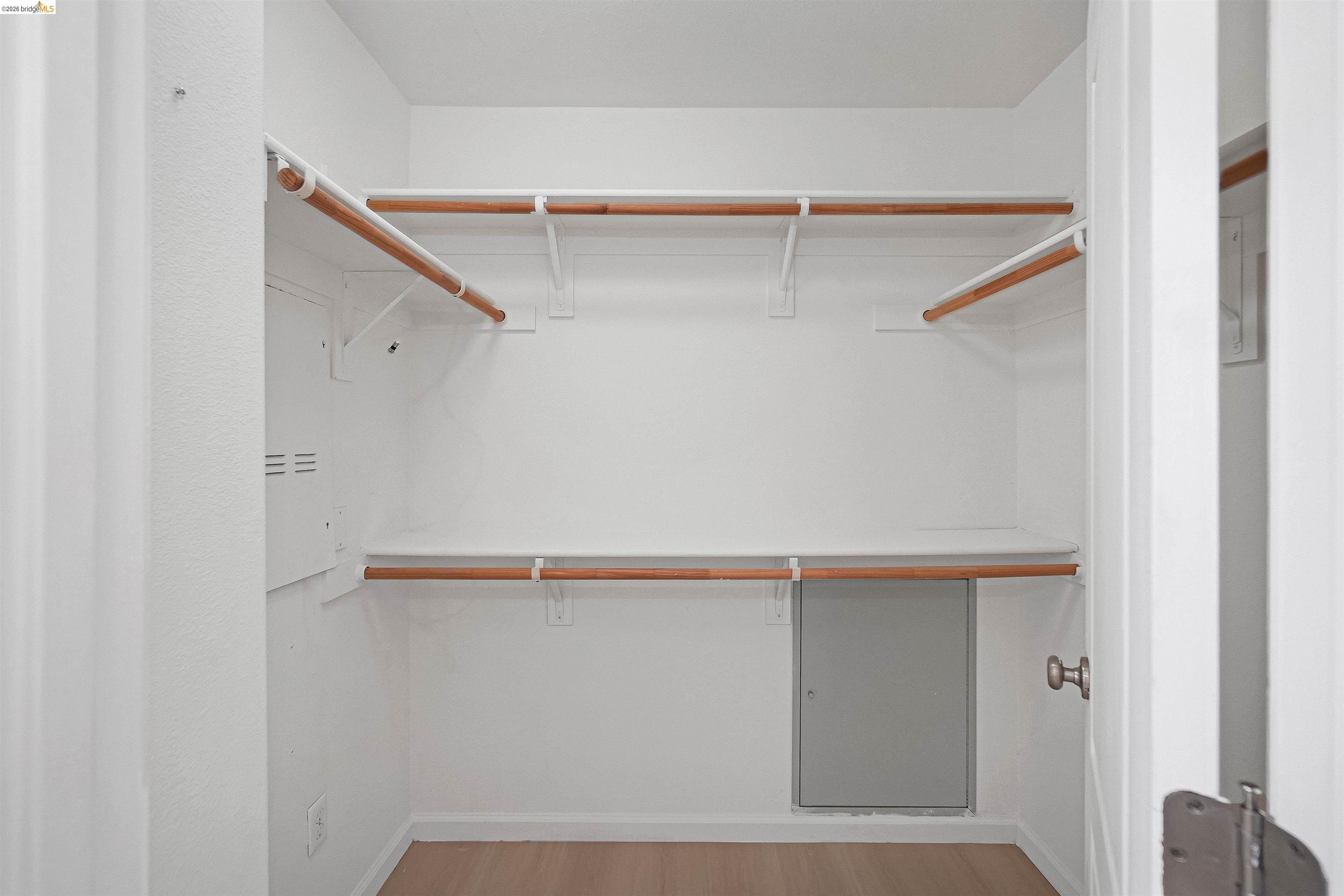 449 Constantine Court San Ramon, CA 94583 - Photo 46 of 63 Walk-in closet featuring white shelving, wood-finish hanging rods, and wood-finish flooring