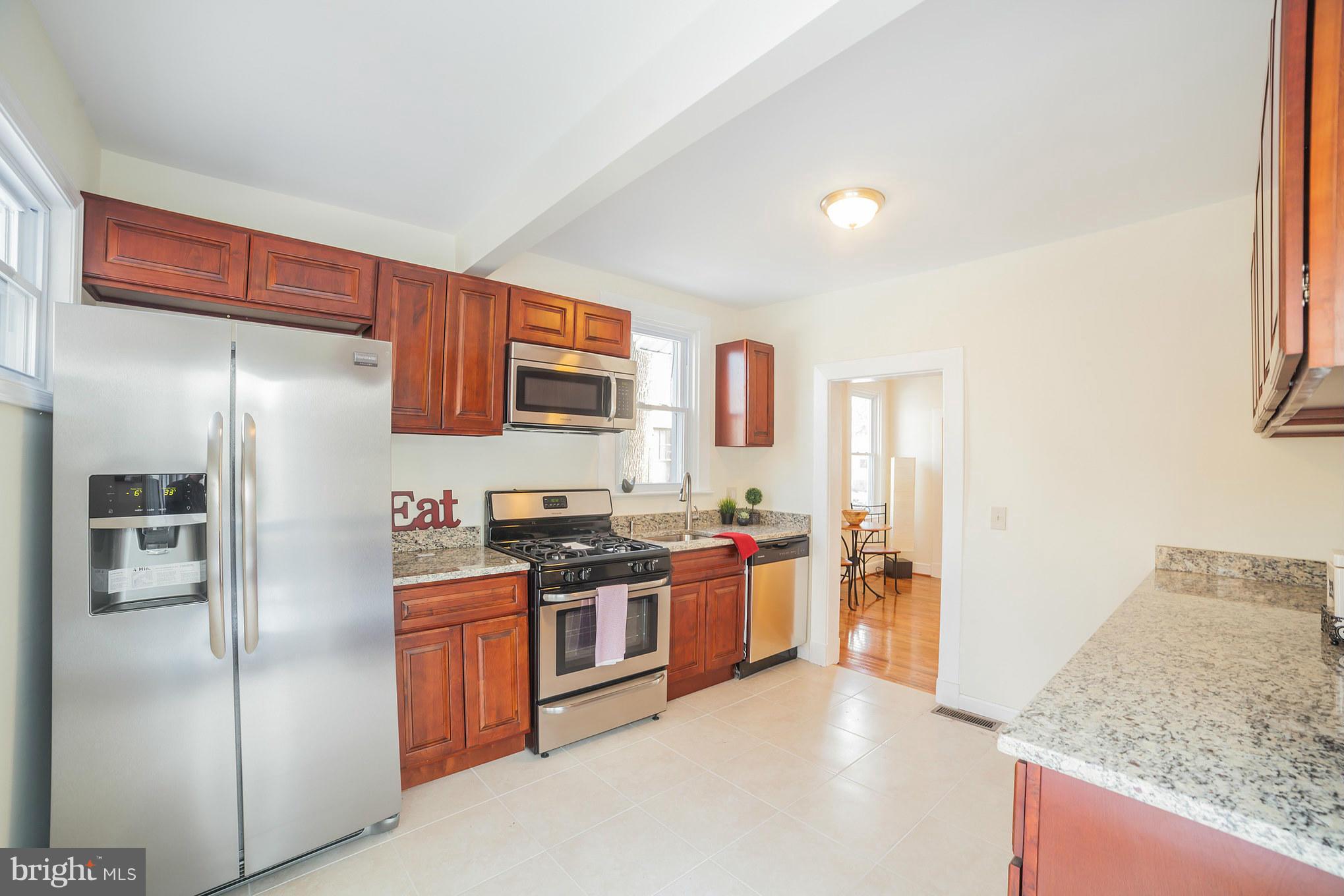 3706 Ferndale Avenue Baltimore, MD 21207 - Photo 11 of 27 a kitchen with stainless steel appliances granite countertop a refrigerator stove and sink