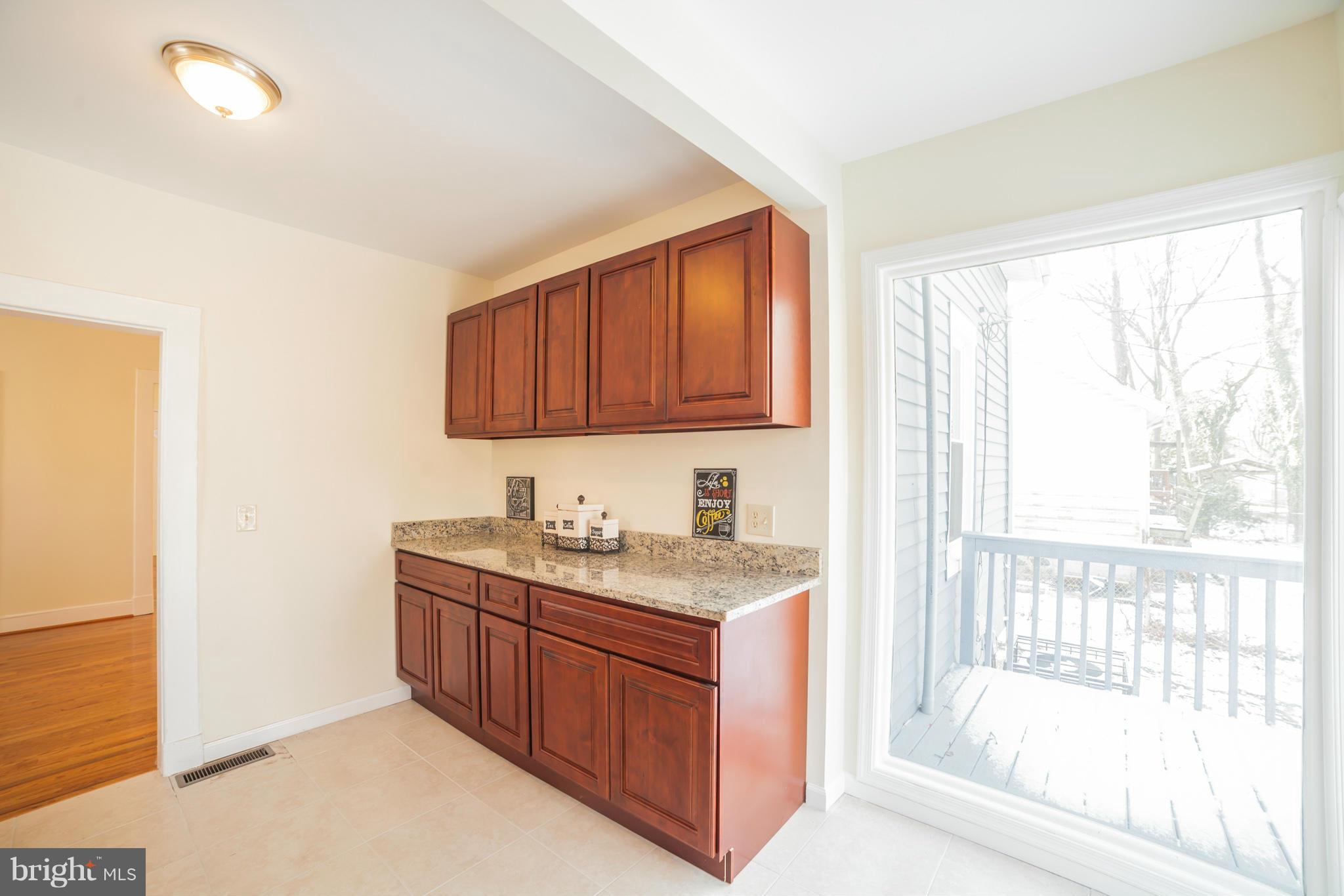 3706 Ferndale Avenue Baltimore, MD 21207 - Photo 13 of 27 a bathroom with a granite countertop sink and a bathtub