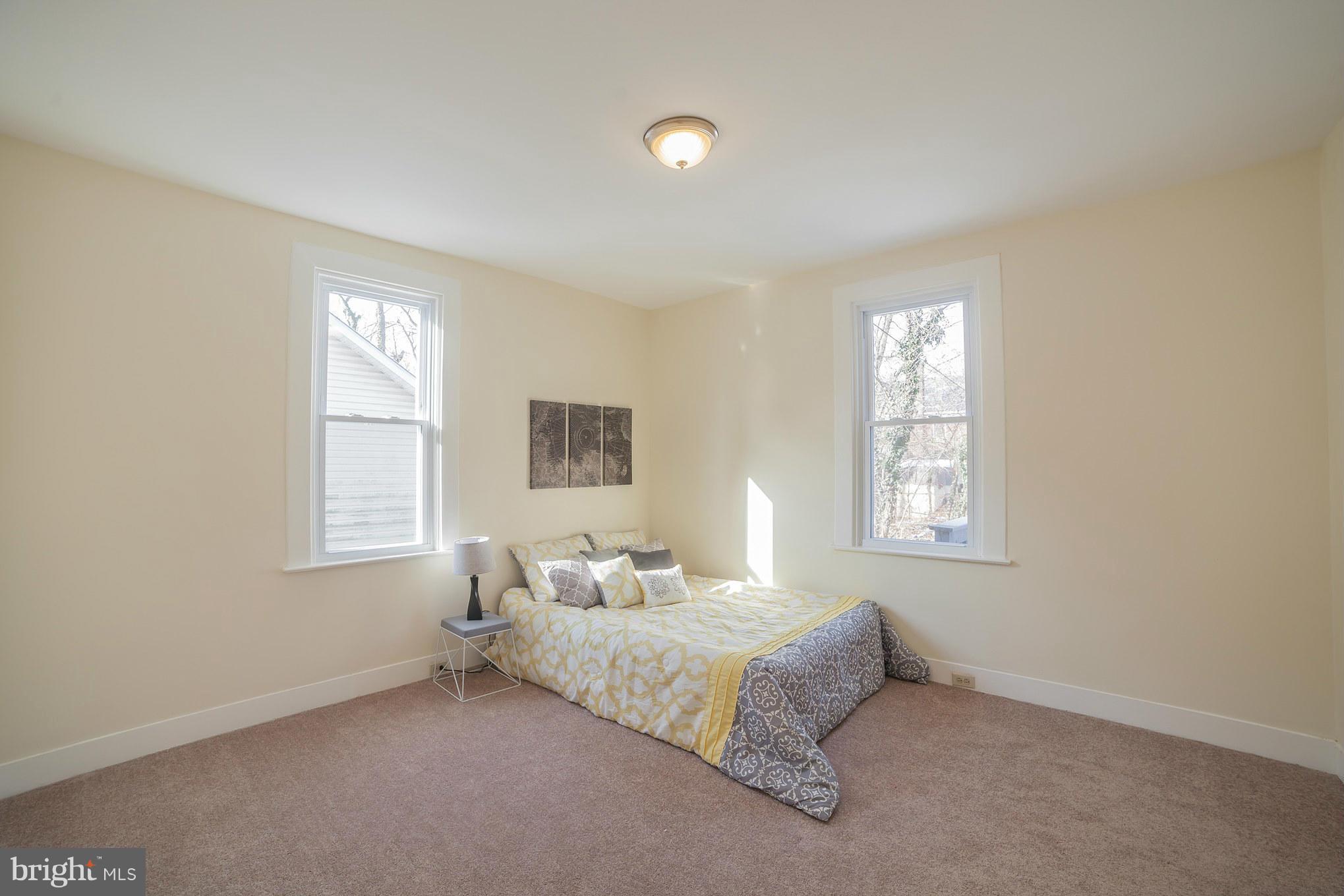 3706 Ferndale Avenue Baltimore, MD 21207 - Photo 15 of 27 a bedroom with a bed and a window