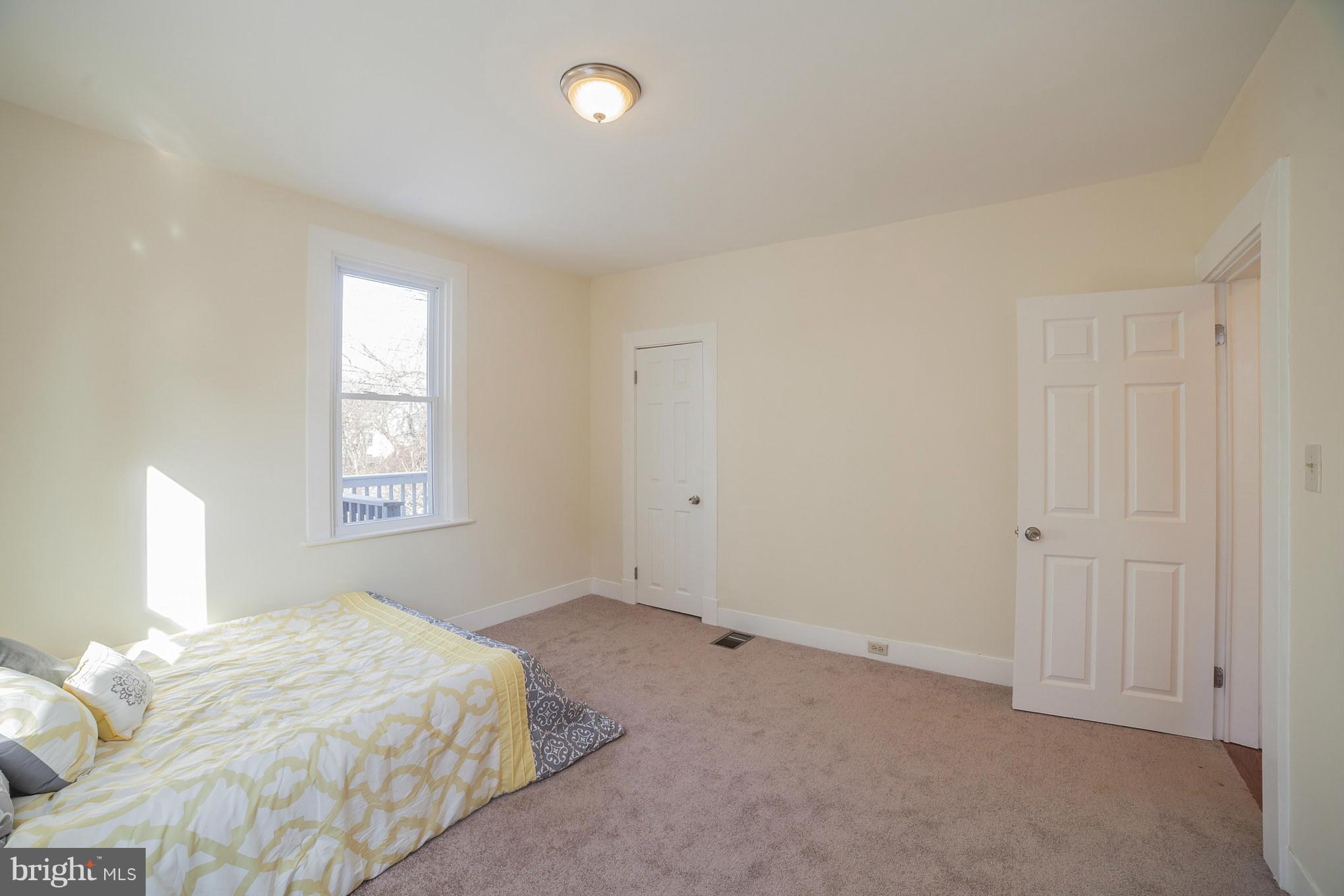 3706 Ferndale Avenue Baltimore, MD 21207 - Photo 16 of 27 a bedroom with a bed and a window