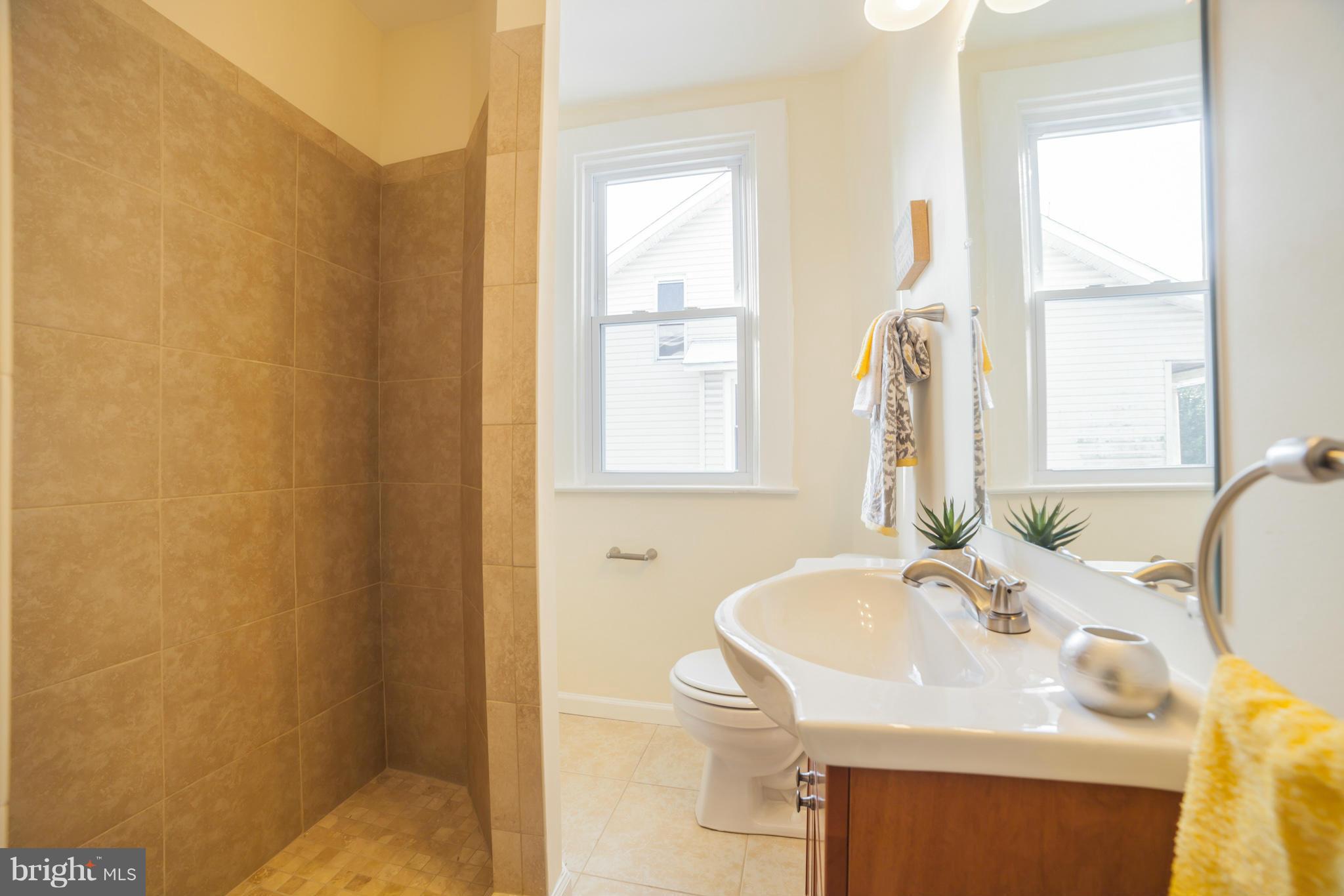 3706 Ferndale Avenue Baltimore, MD 21207 - Photo 17 of 27 a bathroom with a sink and a mirror