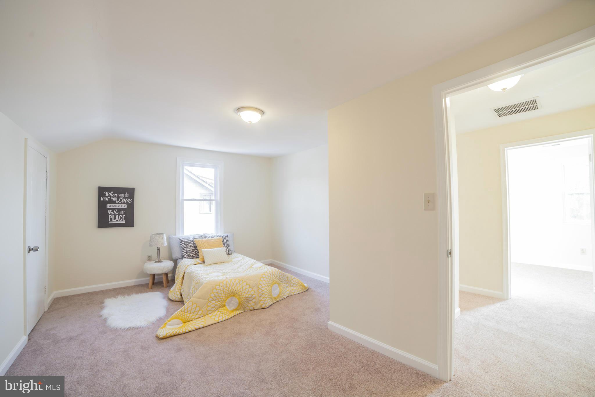 3706 Ferndale Avenue Baltimore, MD 21207 - Photo 18 of 27 a bedroom with a bed and a window