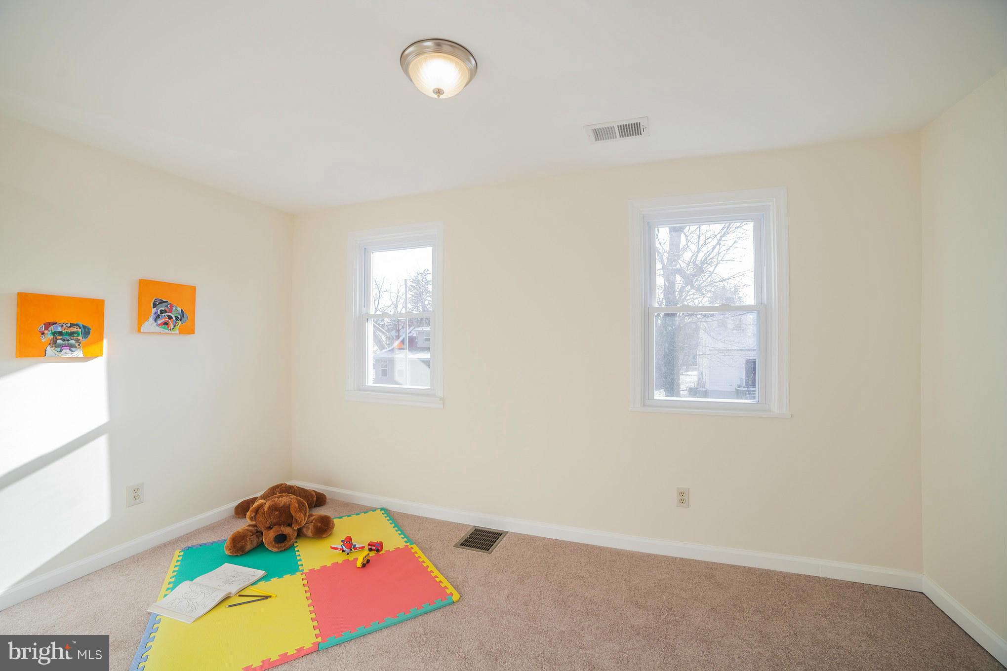 3706 Ferndale Avenue Baltimore, MD 21207 - Photo 21 of 27 a bedroom with bed and a window