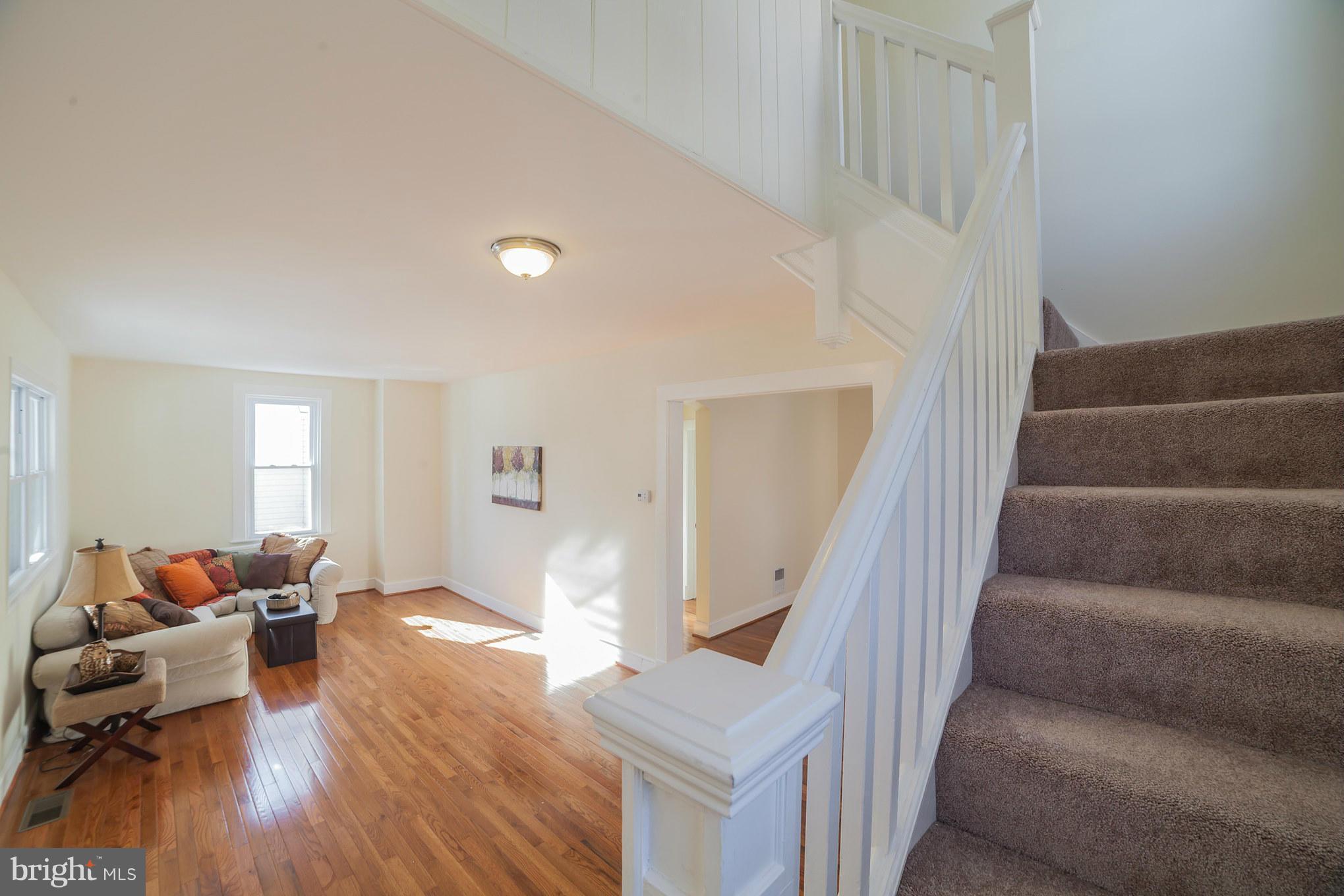 3706 Ferndale Avenue Baltimore, MD 21207 - Photo 4 of 27 a living room with furniture and a wooden floor