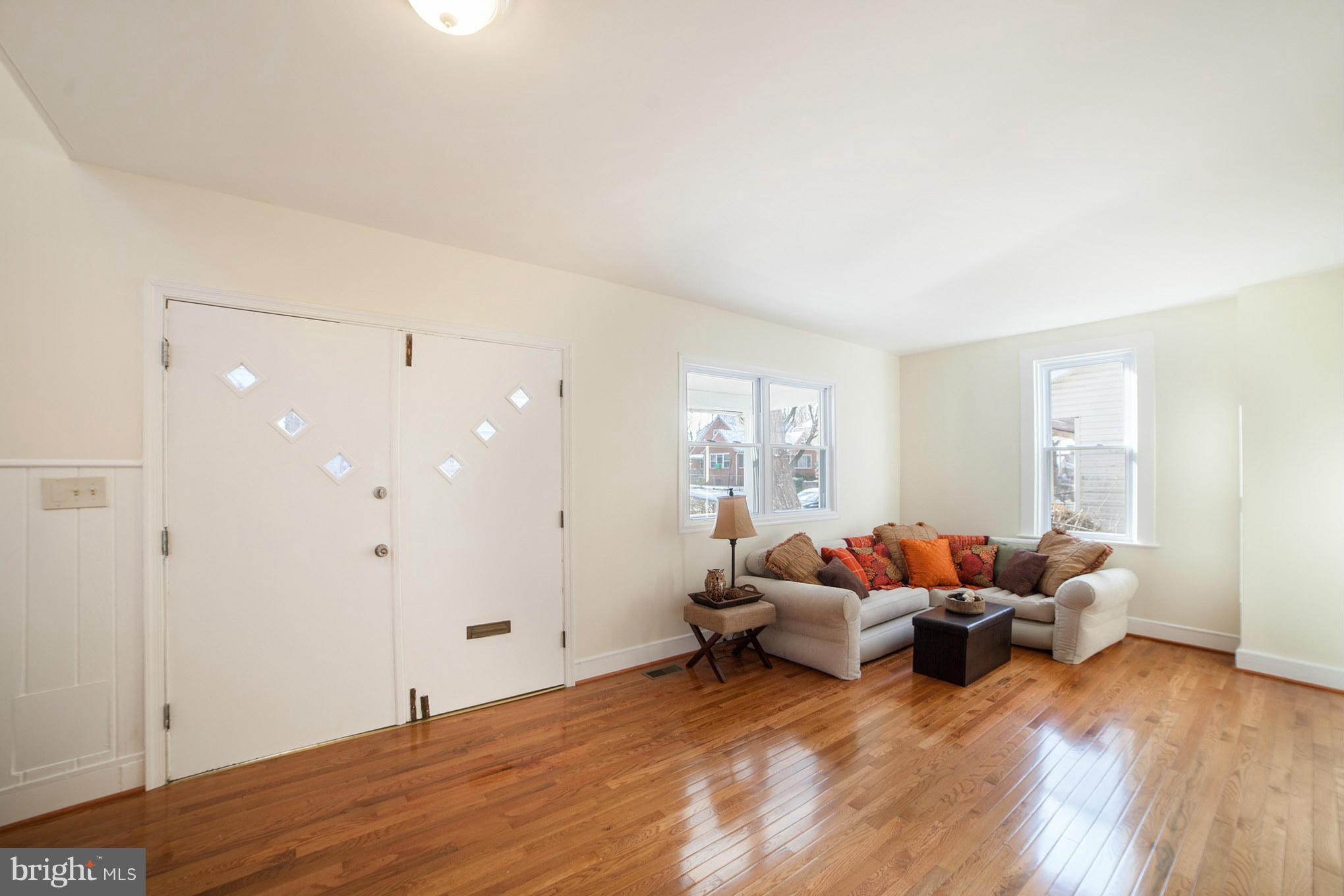 3706 Ferndale Avenue Baltimore, MD 21207 - Photo 5 of 27 a living room with furniture and wooden floor
