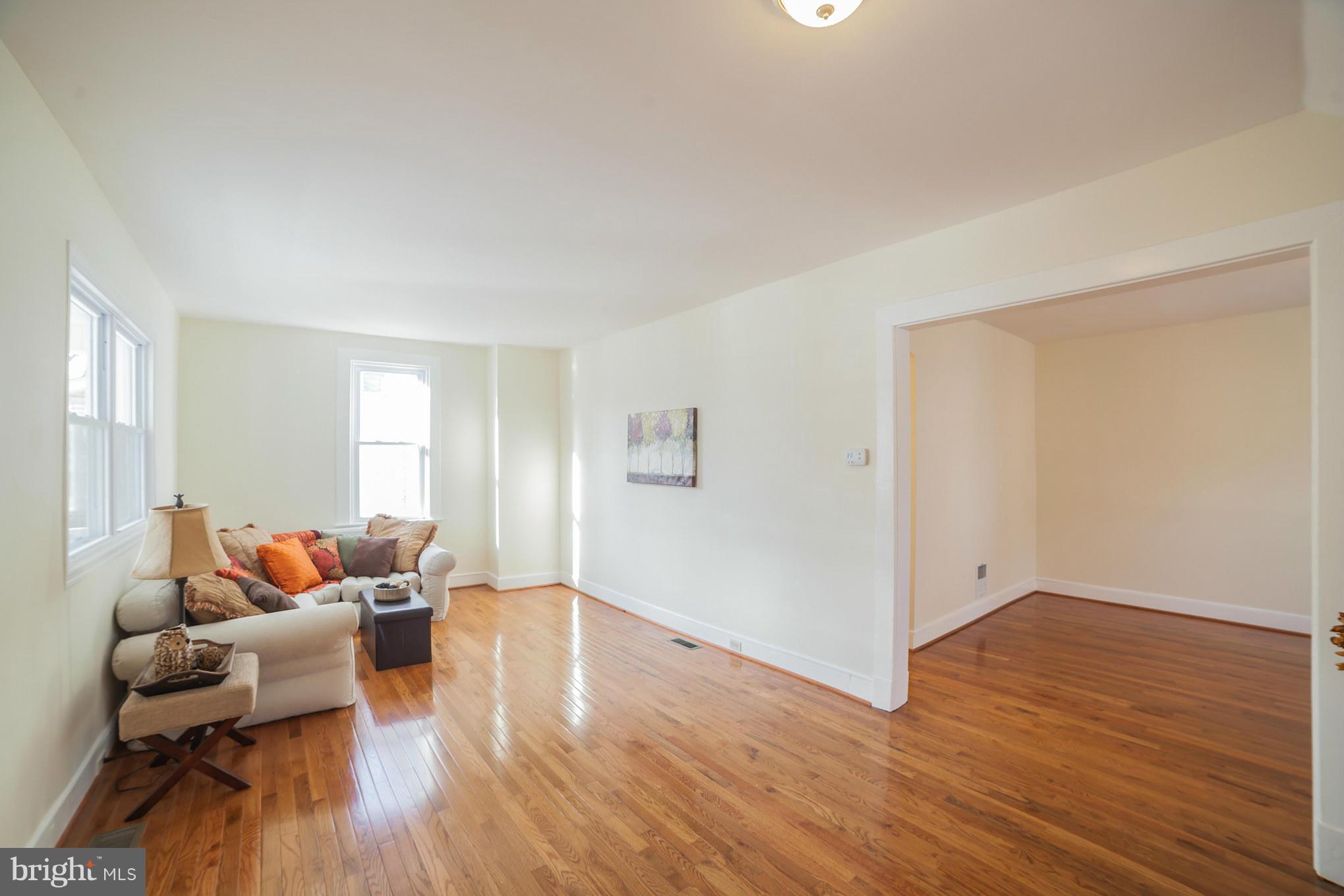 3706 Ferndale Avenue Baltimore, MD 21207 - Photo 6 of 27 a living room with furniture and wooden floor