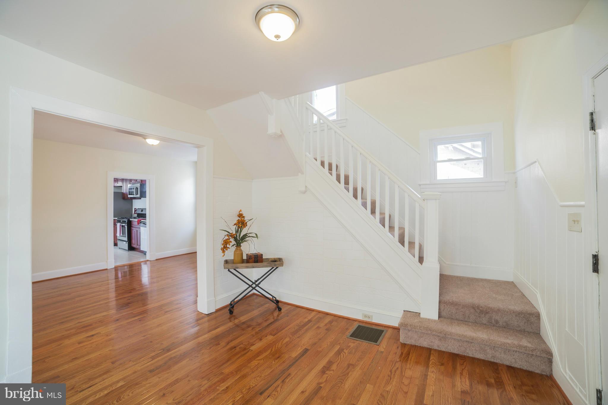 3706 Ferndale Avenue Baltimore, MD 21207 - Photo 7 of 27 a view of entryway and hall with wooden floor