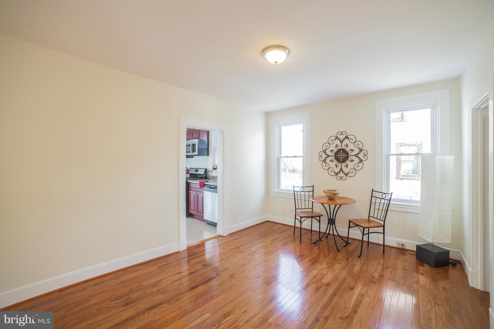 3706 Ferndale Avenue Baltimore, MD 21207 - Photo 8 of 27 a view of a livingroom with wooden floor and a window