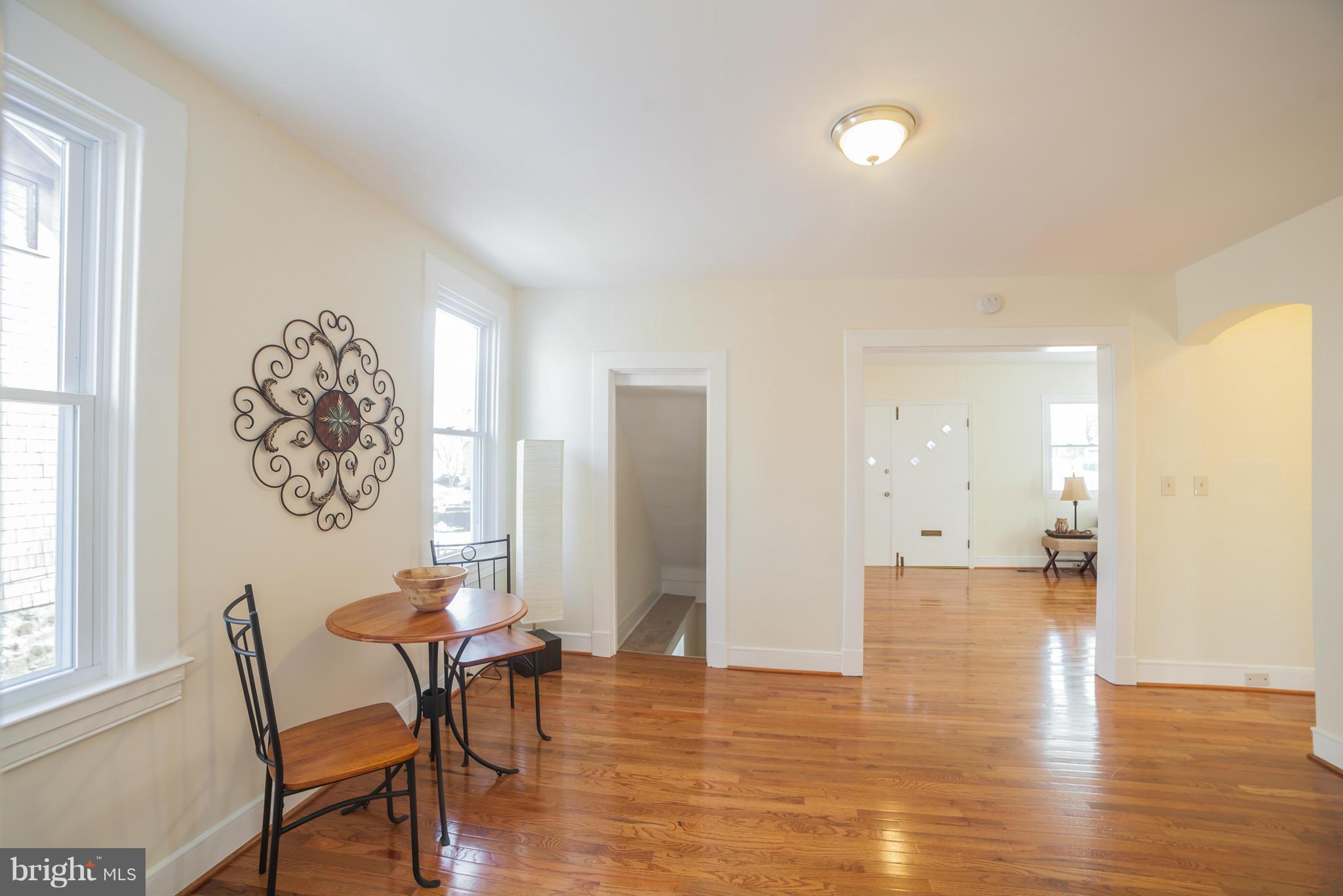 3706 Ferndale Avenue Baltimore, MD 21207 - Photo 9 of 27 a view of a dining room with furniture and wooden floor