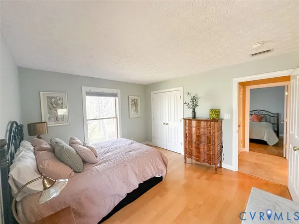 a bedroom with two beds and a window