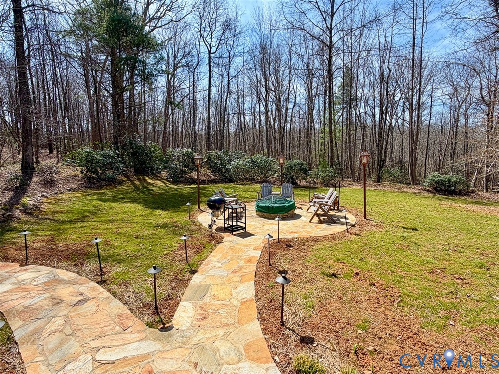 311 Dan River Road Meadows Of Dan, VA 24120 - Photo 10 of 50 a view of a swimming pool with a bench and trees in the background