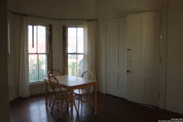 a view of a livingroom with furniture and hardwood floor