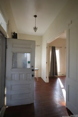 a view of hallway with wooden floor