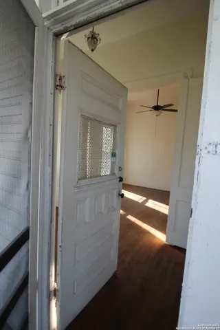 a view of empty room with wooden floor