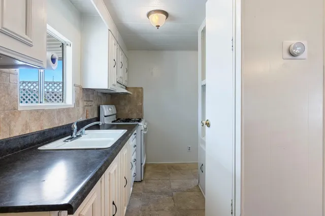 a stove top oven sitting inside of a kitchen