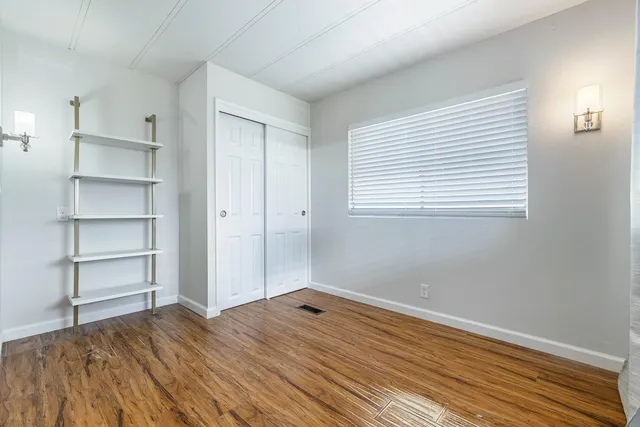 a view of a room with wooden floor