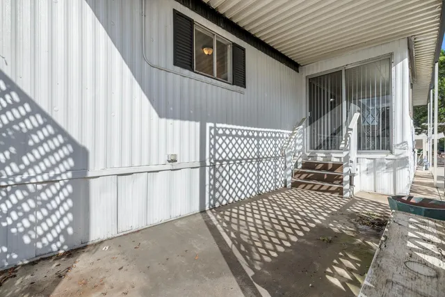 a view of a backyard with sitting area and garden
