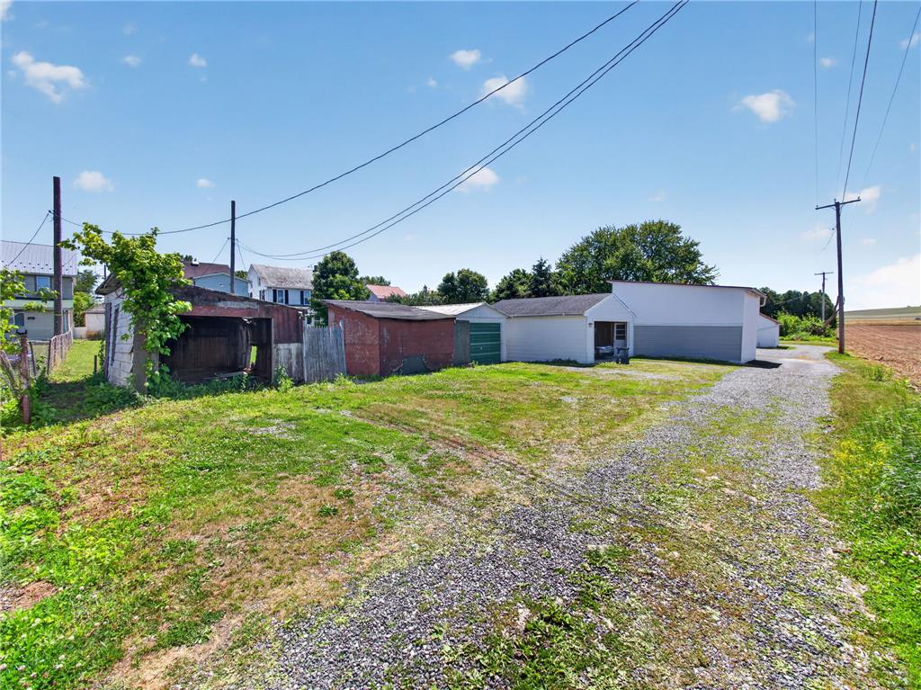 15845 Kutztown Road Mertztown, PA 19539 - Photo 24 of 24 A long, gravel driveway provides ample parking leading to several outbuildings, perfect for storage or workshops.
