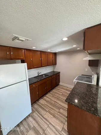 a kitchen with a refrigerator and a stove