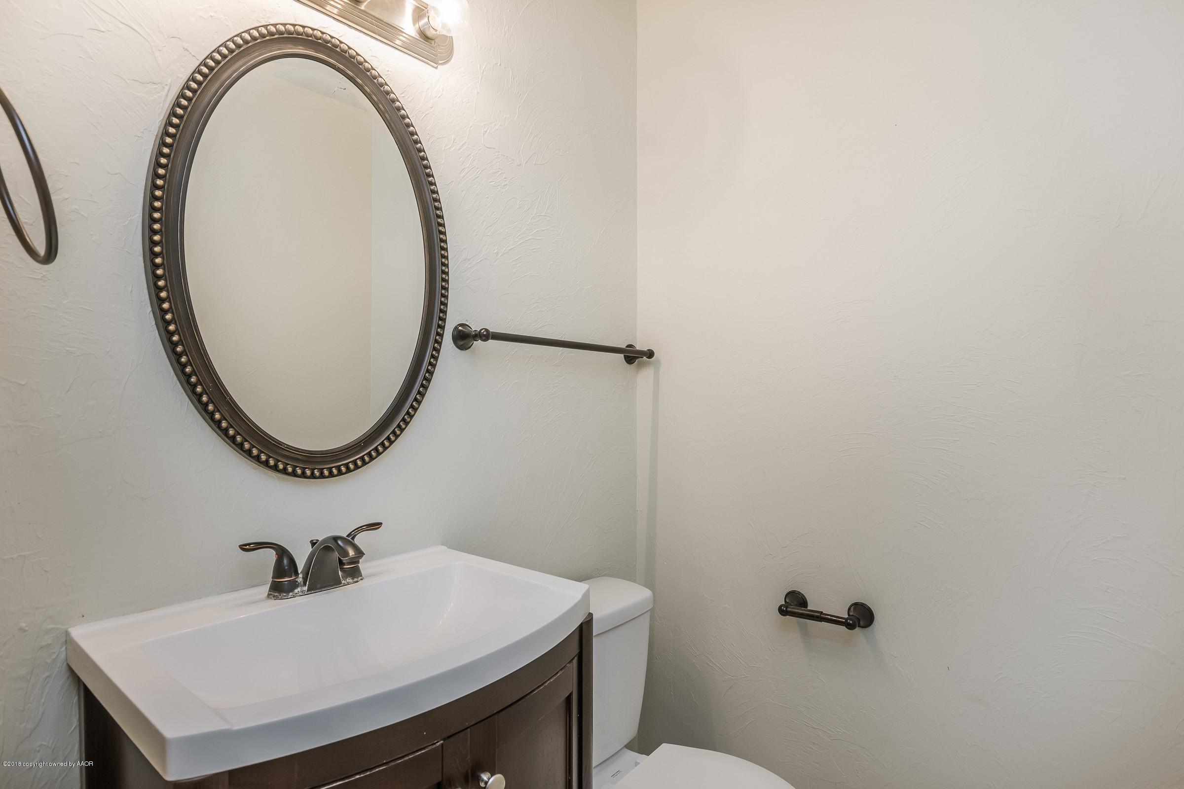 3312 Lombard Road Amarillo, TX 79106 - Photo 13 of 23 a bathroom with a sink and a mirror