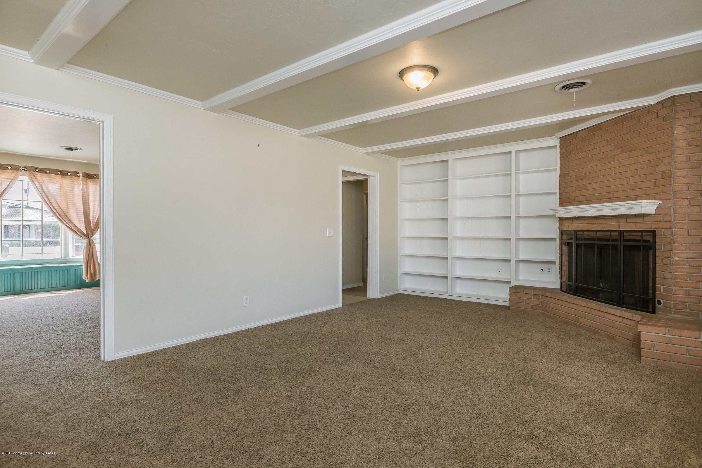 3312 Lombard Road Amarillo, TX 79106 - Photo 6 of 23 an empty room with a fireplace and painted walls