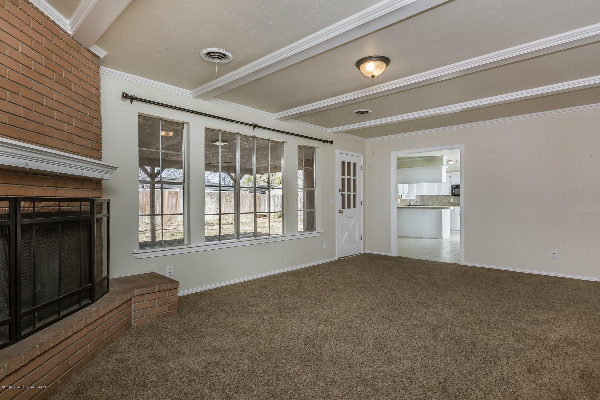 3312 Lombard Road Amarillo, TX 79106 - Photo 7 of 23 a view of an empty room with a fireplace and a window