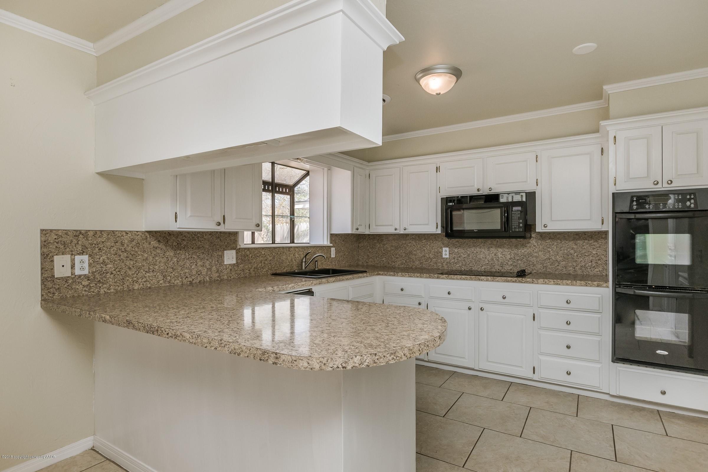 3312 Lombard Road Amarillo, TX 79106 - Photo 9 of 23 a kitchen with granite countertop white cabinets and stainless steel appliances