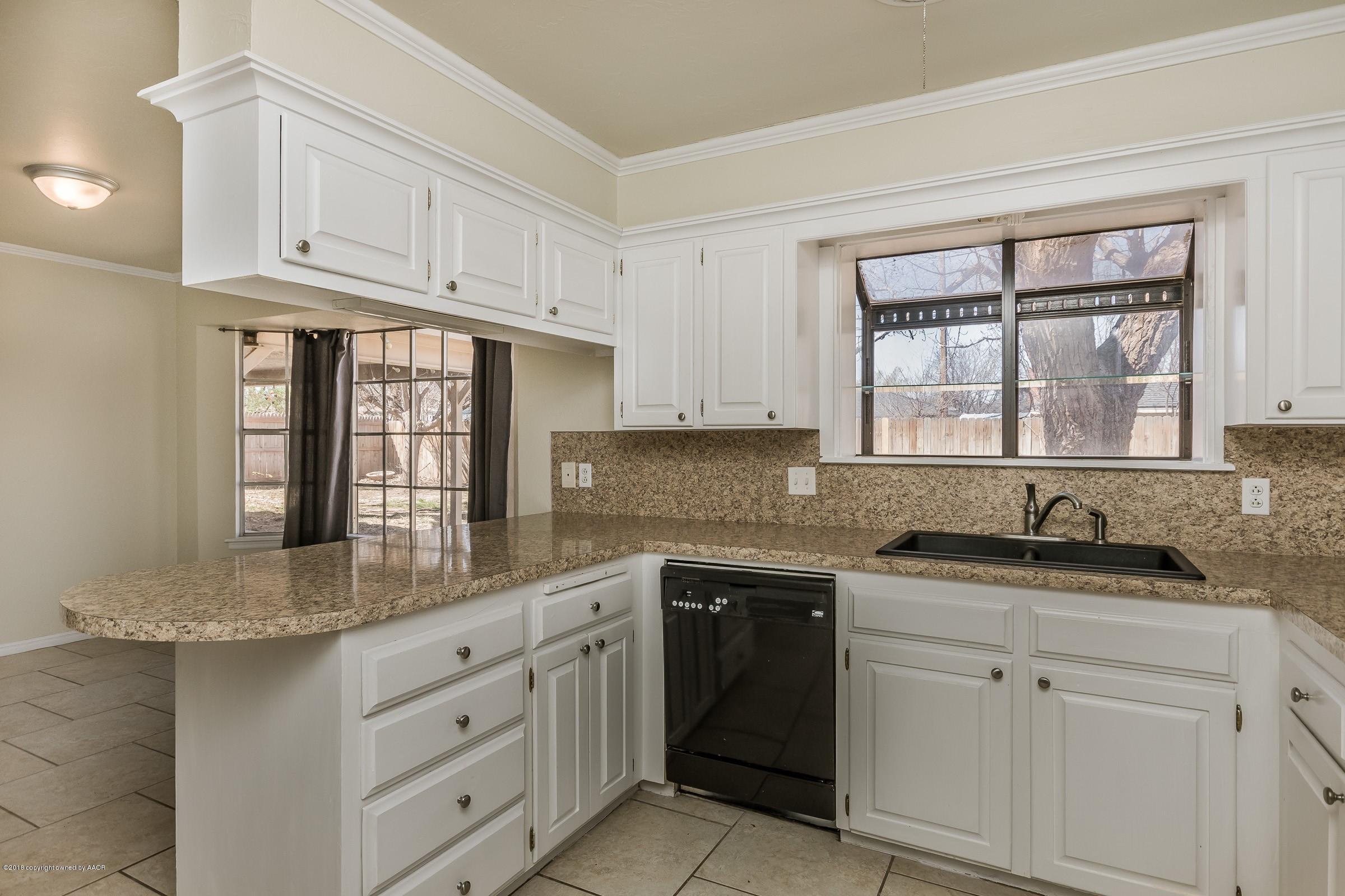 3312 Lombard Road Amarillo, TX 79106 - Photo 10 of 23 a kitchen with granite countertop white cabinets white appliances and a sink