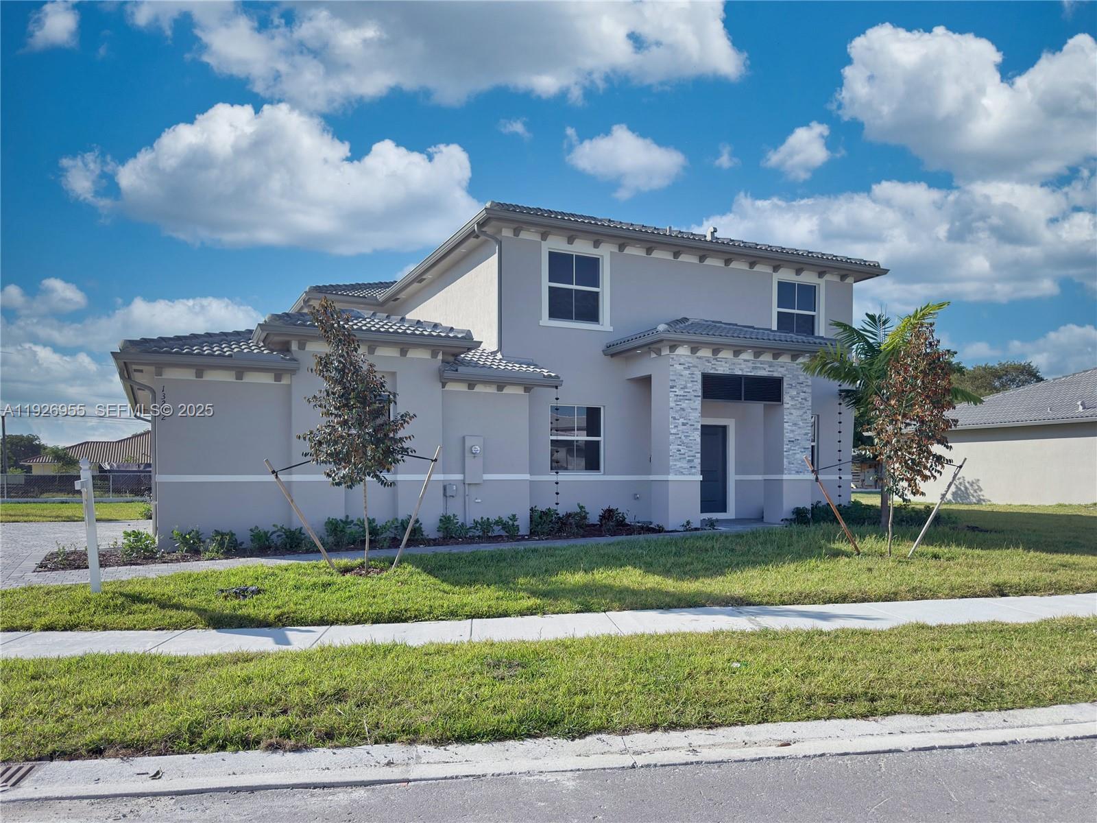 13202 Southwest 189th Terrace Miami, FL 33157 - Photo 1 of 34 a view of a house with a big yard potted plants and large tree