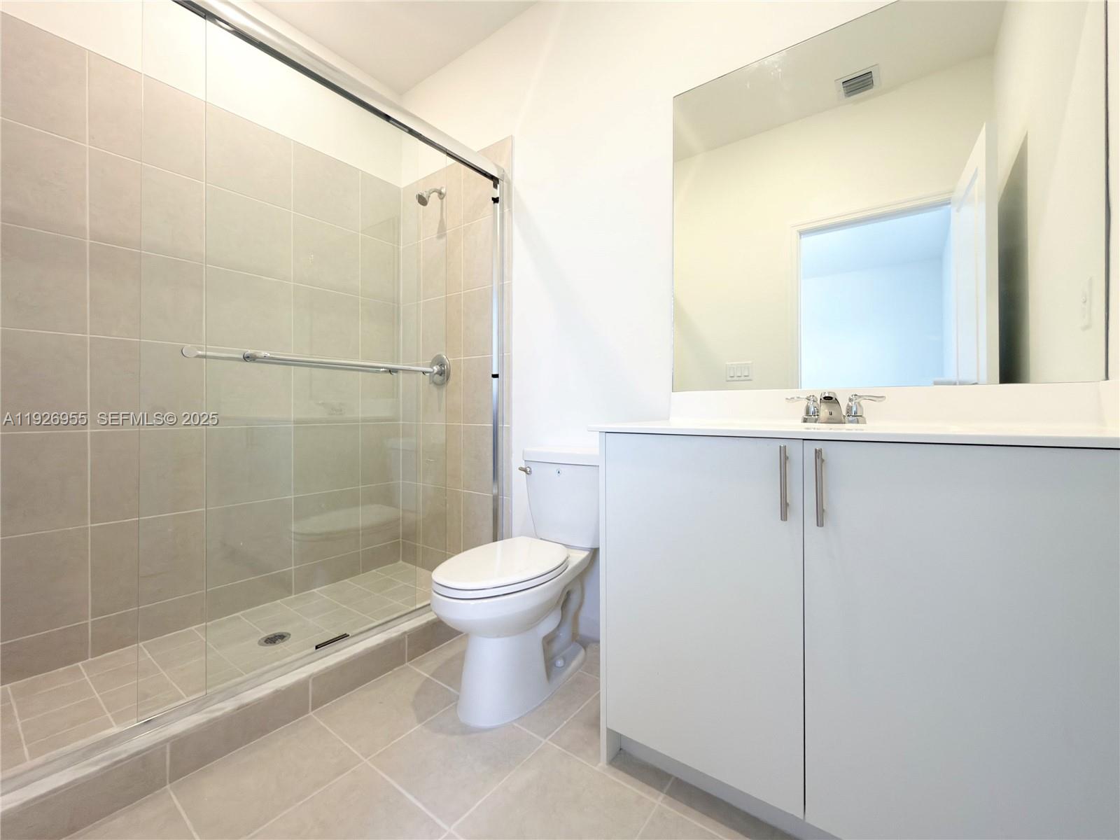 13202 Southwest 189th Terrace Miami, FL 33157 - Photo 22 of 34 a bathroom with a shower toilet and sink