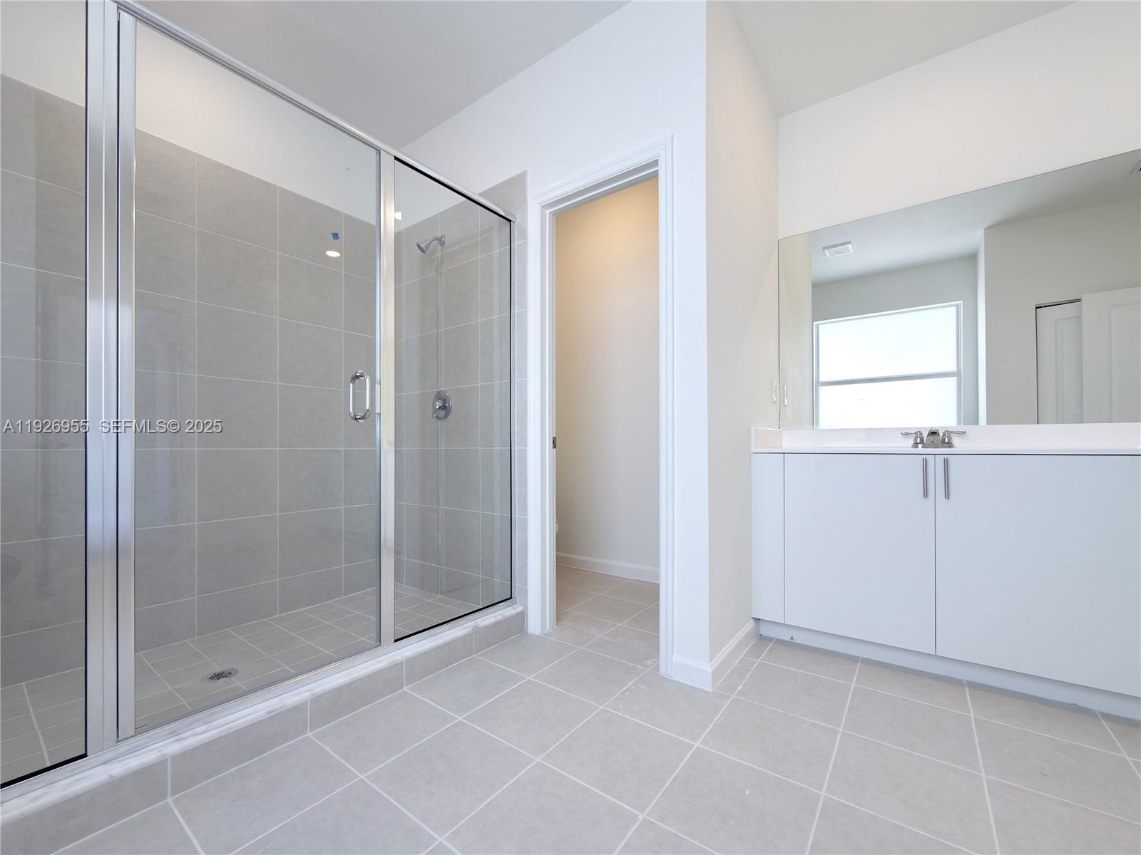 13202 Southwest 189th Terrace Miami, FL 33157 - Photo 30 of 34 a bathroom with a shower and a glass door