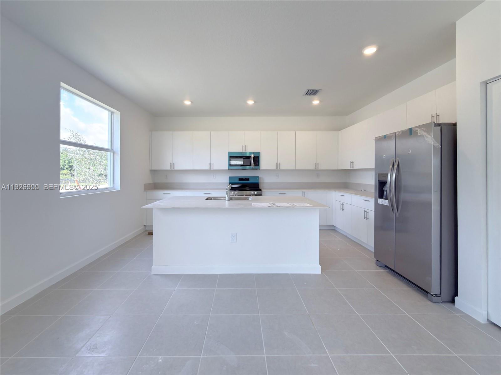 13202 Southwest 189th Terrace Miami, FL 33157 - Photo 3 of 34 a kitchen with stainless steel appliances a refrigerator sink and microwave