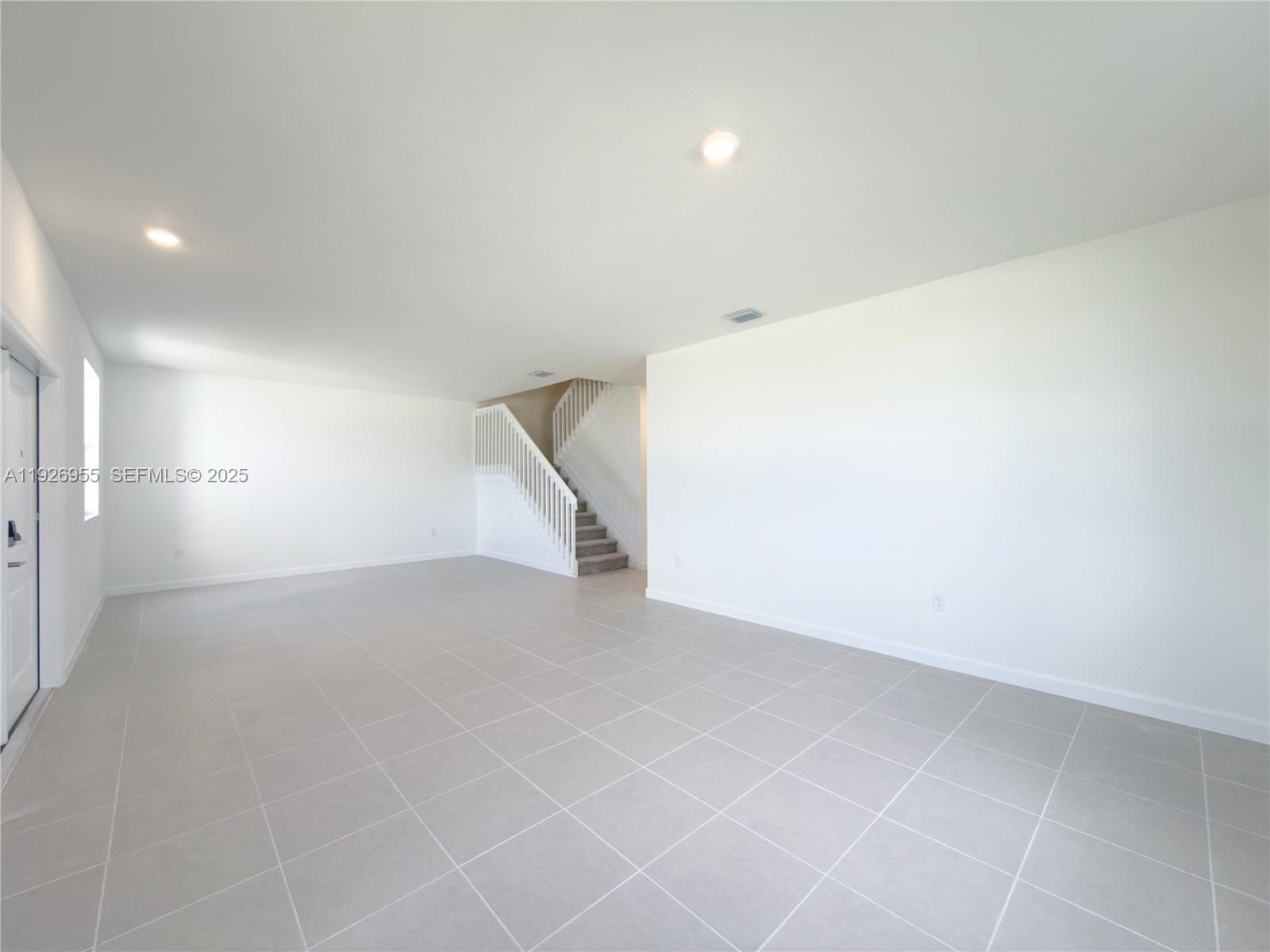 13202 Southwest 189th Terrace Miami, FL 33157 - Photo 31 of 34 an empty room with white walls and tiles