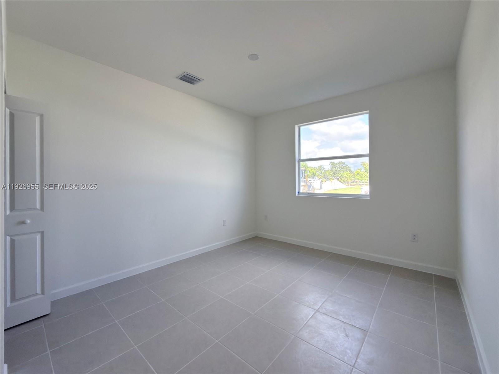 13202 Southwest 189th Terrace Miami, FL 33157 - Photo 7 of 34 an empty room with a window