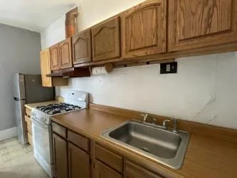 an empty room with windows and ceiling fan
