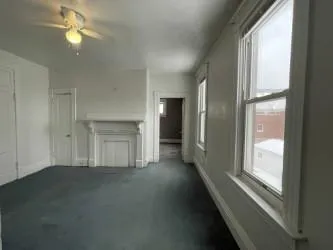 an empty room with a empty space and windows