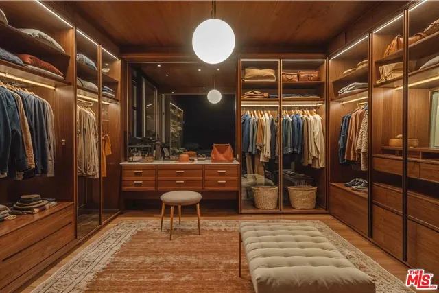 a room with lots of wooden furniture and a shower