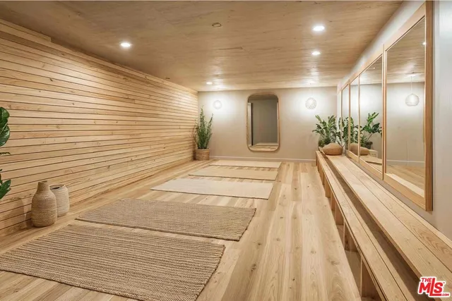 a view of a hallway with two chairs and a large window