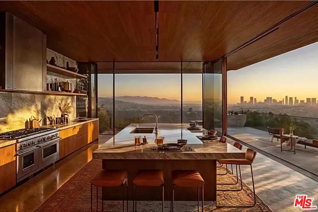 a kitchen with a table chairs stove and sink
