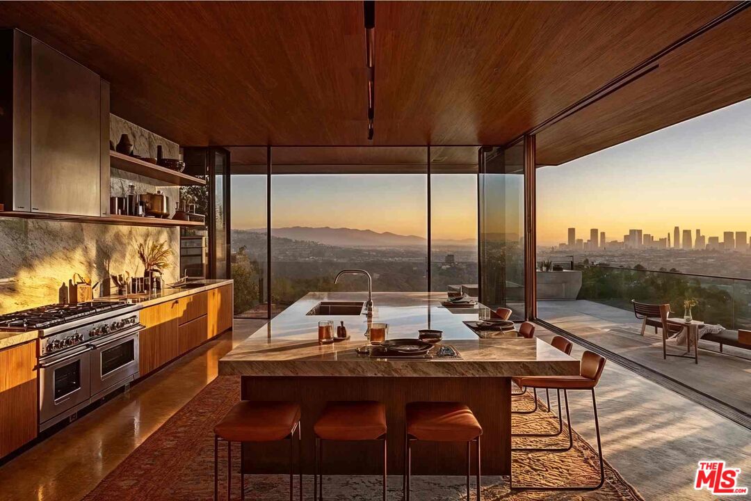 7305 Pyramid Place Los Angeles, CA 90046 - Photo 8 of 36 a kitchen with a table chairs stove and sink