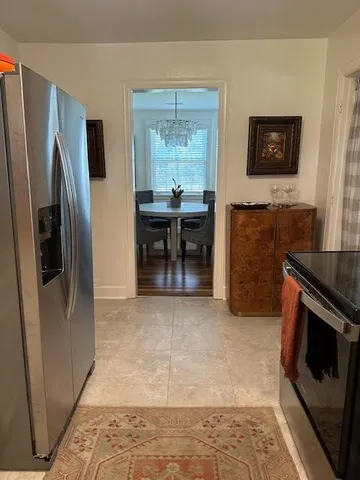 a kitchen with granite countertop a sink stove and refrigerator