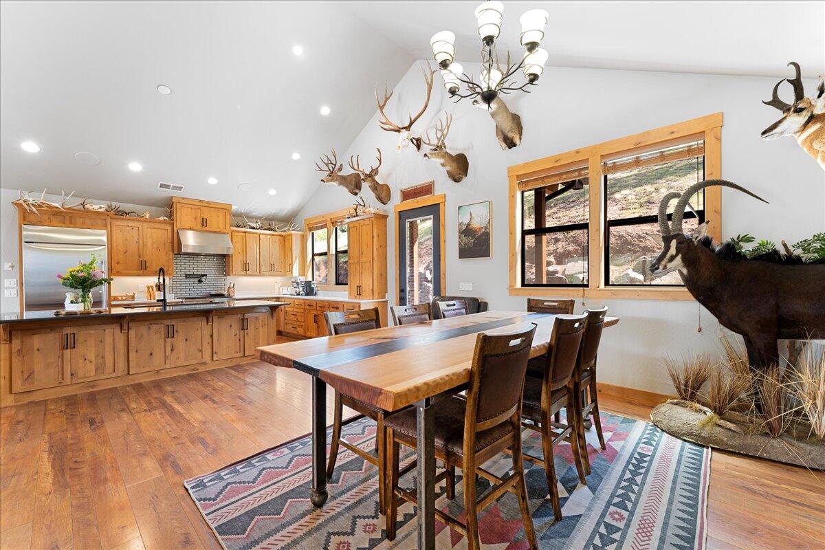 2220 Butte Falls Highway Eagle Point, OR 97524 - Photo 20 of 69 a view of a dining room with furniture a chandelier and wooden floor