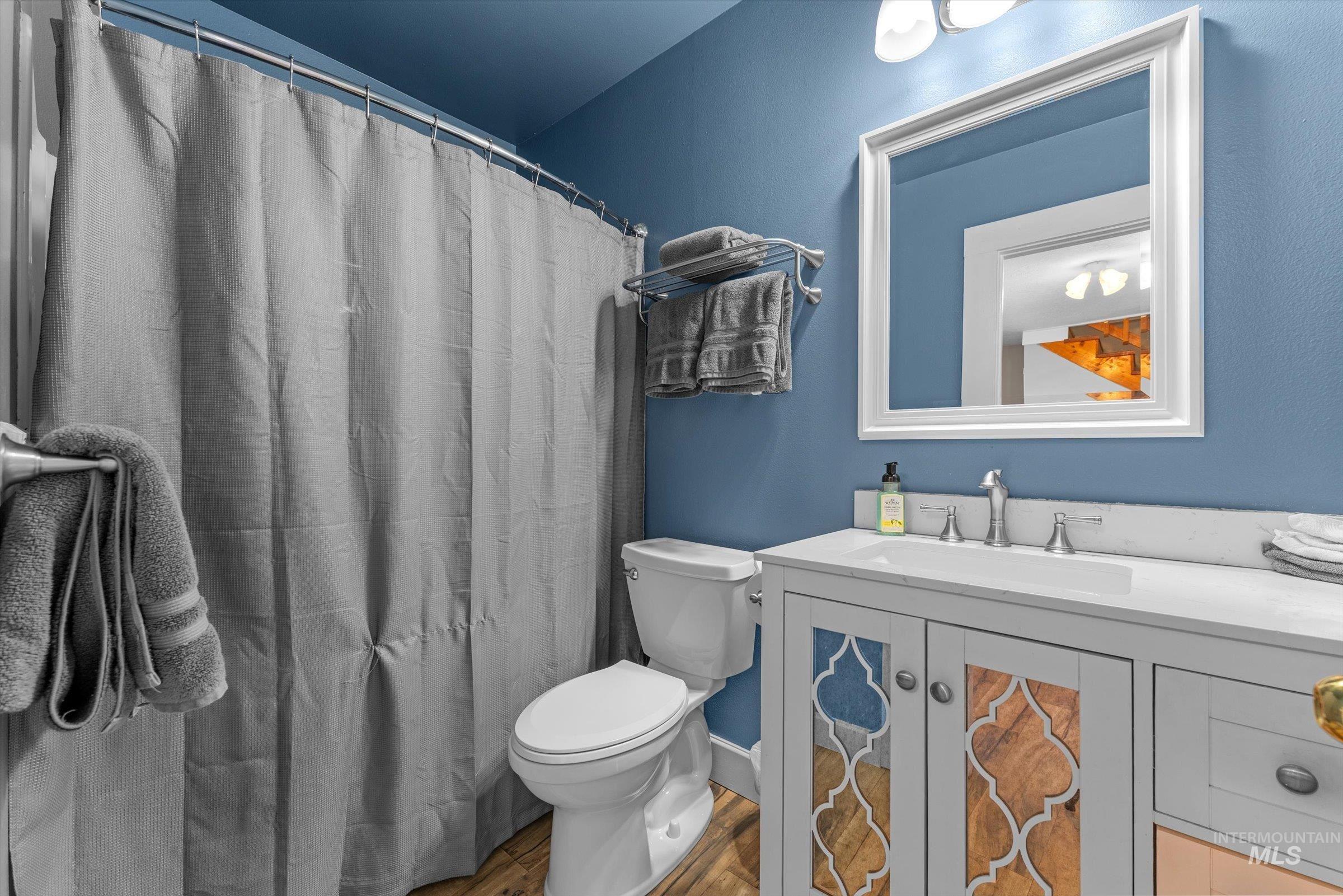 315 South Middlefork Road Garden Valley, ID 83622 - Photo 30 of 49 Full bath featuring vanity, wood finished floors, and a shower with curtain