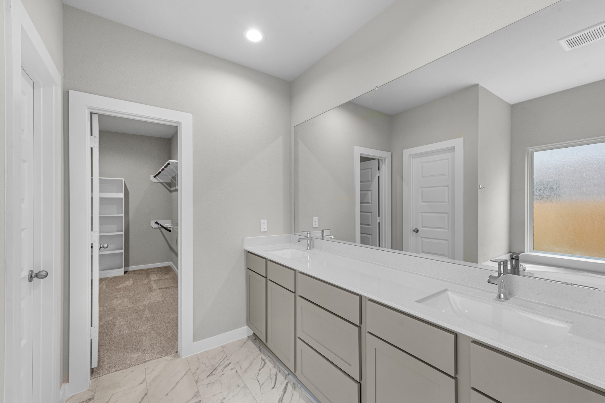 3107 Spitfire Drive Rosenberg, TX 77471 - Photo 12 of 39 a bathroom with a double vanity sink and a mirror