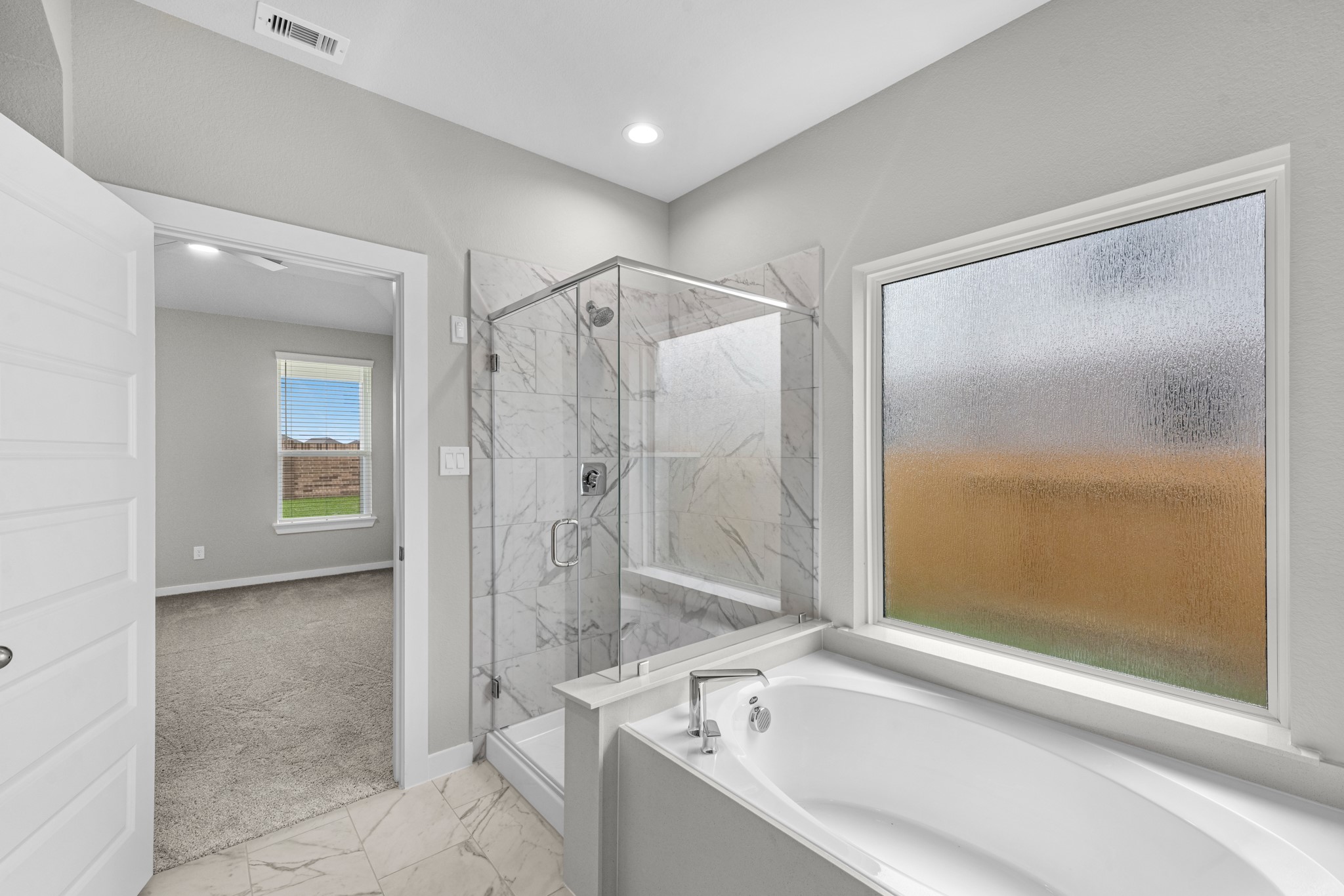3107 Spitfire Drive Rosenberg, TX 77471 - Photo 13 of 39 a bathroom with a bathtub and a shower